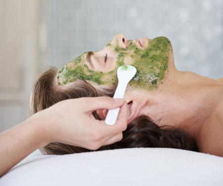 Man receiving facial at luxury spa